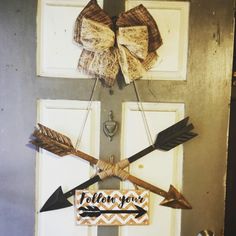 a door with an arrow and bow hanging on it