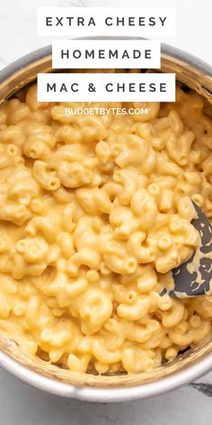 macaroni and cheese in a silver bowl with the words extra cheesy homemade mac and cheese