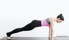 a woman is doing a yoga pose on a mat