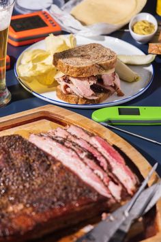 there is a large piece of meat on the plate next to a glass of beer