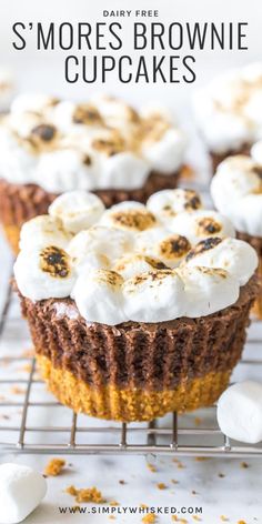 some cupcakes that have marshmallow toppings on them and the words, s'mores brownie cupcakes