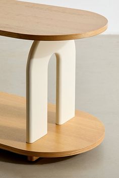 a wooden table with two white objects on it's sides and a circular base