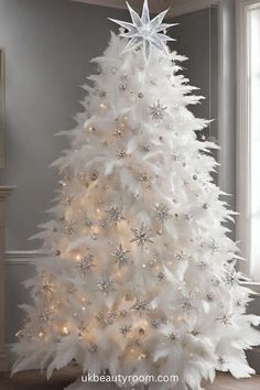 a white christmas tree with snowflakes and lights