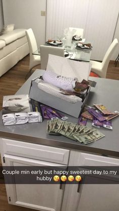 a counter topped with lots of money sitting on top of a kitchen counter