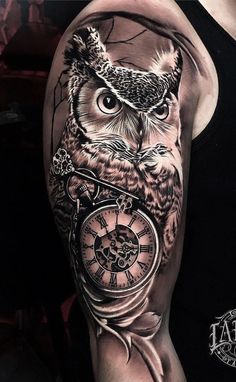 an owl with a clock tattoo on his arm is shown in black and grey colors