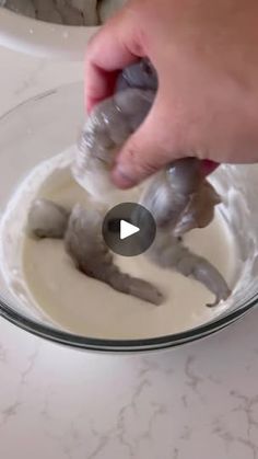 someone is mixing batter in a glass bowl