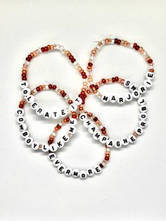 four bracelets with words on them that spell out the names of three different people