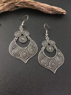 Indus Earrings : Back to our Roots. For the women who makes a statement.  An exclusive shop for earrings. Wear them with pride.  These are dangling drops style earrings . An unique handmade Indian style ethnic bohemian/ Tribal earrings in silver shade.  These earrings are made from high quality Tatanium / German silver material  which are hypoallergenic and free from corrosion & rusting.  Notes : The product shipped will be same as shown in the picture, however the actual colours may vary slightly due to the natural lighting in the photography. We do not accept returns or refunds , however in case of any issues we will definitely try and resolve it. Bohemian Teardrop Pierced Earrings, Bohemian Metal Plug Earrings For Pierced Ears, Bohemian Pierced Chandelier Earrings For Festivals, Bohemian Silver Teardrop Earrings, Bohemian Metal Chandelier Earrings With Ear Wire, Bohemian Metal Danglers For Pierced Ears, Nickel-free Bohemian Chandelier Earrings, Bohemian Metal Chandelier Earrings, Bohemian Danglers With Intricate Design