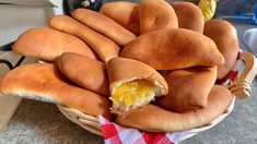 a basket filled with lots of bread on top of a counter