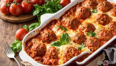 a casserole dish filled with meatballs and cheese, garnished with parsley