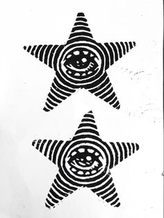 two black and white stars with faces drawn on them