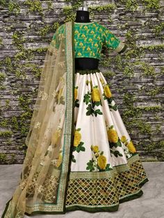 Yellow Giant Rose Florals printed on lehengas with Heavily Embroidered Blouse. that its called “Rani Sahiba ke Pardesi Gulab”
A modern floral print lehenga in off white color and it is crafted with machine embroidery work on the broad border part.
This designer lehenga comes with embroidery work crop top and dupatta. Skirt has cancan fabric on the under layer part.

Product Code: ZC7003
LEHENGA (Semi-Stitched):FABRIC : Banglory silkWORK   : Digital print with Dori and Sequi White Anarkali Lehenga With Floral Print, Semi-stitched Silk Lehenga With Floral Print, Yellow Floral Print Lehenga For Wedding, Fitted Yellow Lehenga With Floral Print, Green Floral Print Lehenga For Wedding, Green Floral Print Wedding Lehenga, Yellow Floral Print Lehenga For Navratri, Yellow Floral Print Choli For Wedding, Anarkali Yellow Lehenga With Floral Print