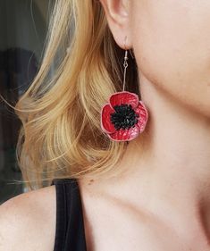 "Statement Leather Poppy earrings with gorgeous up-cycled leather in red and black An unique piece of jewelry, entirely handmade with red Italian leather. It is a very fun accessory, especially for poppy fields lovers. The middle is made with black leather fringe. These statement poppy flowers are treated for a 3D effect and protected with clear varnish for durability. Stainless steel earrings with rubber stoppers.  { S i z e } 3\"/  7 cm long  Diameter of the flower: ~ 3.5 cm (1.4 inch) Matching poppy ring: https://etsy.me/3IrPwnV Matching necklace: https://etsy.me/3bSofPi Matching poppy brooch: https://etsy.me/3yP3P2U  PLEASE NOTE THIS IS A UNIQUE HANDMADE PRODUCT AND EACH PIECE WILL BE SLIGHTLY DIFFERENT THAN THE OTHERS ( different shade of leather, but really similar, depending on my s Unique Red Flower Earrings, Handmade Red Flower Earrings For Party, Red Leather Jewelry For Gift, Red Leather Jewelry For Gifts, Adjustable Red Leather Earrings, Red Leather Earrings For Gifts, Red Leather Jewelry For Party, Red Leather Earrings, Esty Finds