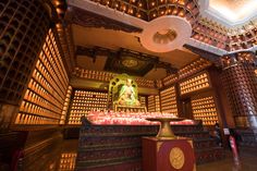 the inside of a temple with many candles