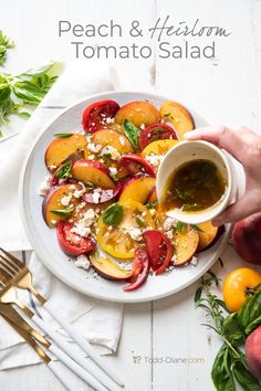 a white plate topped with sliced peaches and feta cheese