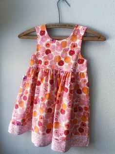 A bright and cheery print of pink and orange grapefruits, this is a perfect dress for Spring/Summer. It is made of 100% cotton very high quality fabric. The sundress skirt border, pocket and bodice lining are made from a coordinating pastel floral print. 2 white buttons fasten at the dress shoulder. Perfect for your summer vacation. the beach or for going back to school in style. The sizing is generous in this sundress and the size usually correlates to the age of an average sized child. Made fr Girls Sundress, Sundress Summer, Girls Pink Dress, Dress For Spring, Boutique Dress, Girls Boutique, Pink Grapefruit, Pink Kids, Pastel Floral