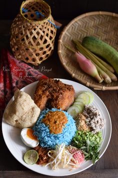 a white plate topped with different types of food on top of a wooden table next to baskets