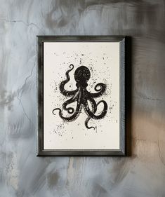 an octopus is hanging on the wall in front of a framed print with black ink