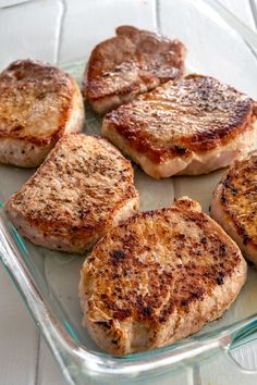 some meat patties in a glass dish on a table