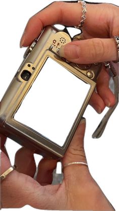 a person holding an old style cell phone in their left hand, with both hands on it