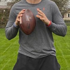 a man holding a football in his hands