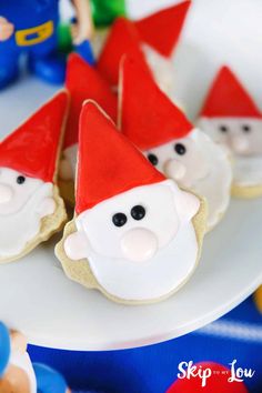 cookies decorated like santa claus on a plate