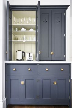 the cabinets are painted blue and have gold handles