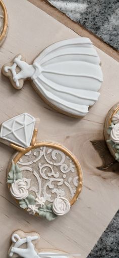 some decorated cookies sitting on top of a cutting board