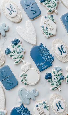 blue and white decorated cookies are arranged on a counter top, with the numbers displayed