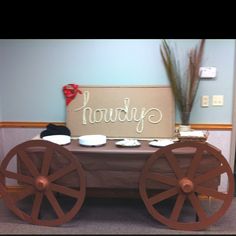 a wagon with the word happily written on it is sitting in front of a sign