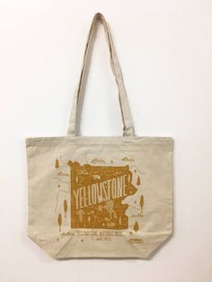 "Take this tote on your next adventure or to the grocery store! This large canvas tote is eco friendly and 1-color screen printed in the USA Totes measure 18\"W x 15\"H x 6\"D, printed image measures about 12\"W x 12\"H. Totes are blank on the back. Material: 12 oz 100% Cotton Canvas Handles: 29\" x 1\" Colors: Tote- Natural Art- Gold Screen printing is hand done and can have slight variations from piece to piece. Colors can vary due to individual monitor settings. Will be shipped padded via USP Canvas Tote Bags For Outdoor Activities, Yellow Tote Bag For Outdoor, Eco-friendly Canvas Travel Bag, Eco-friendly Travel Canvas Bag, Eco-friendly Rectangular Bags For Outdoor Activities, Cotton Tote Bags For Outdoor Activities, Eco-friendly Ink Canvas Tote Bag For Travel, Cotton Tote Bag For Outdoor Activities, Eco-friendly Canvas Tote Bag For Outdoor