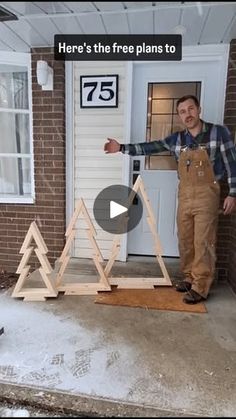 a man standing in front of a white door with three wooden pyramids on it