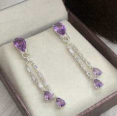 This Earring is made from  Natural Purple Amethyst and 925 sterling silver. This Dangle Earring is finely polished to give a brilliant mirror finish. With rejuvenating design and sleek appearance, this Earrings looks stunning on Ear Material :- (Silver) 925 Solid Sterling Silver Gemstone :- Natural Purple Amethyst  Item Weight :- 8.90 Grams Approx. Stone Size :- 8 x 12 MM & 5 x 7 MM. Stone Shape :- Pear Cut Secondary Stone :- 2x4mm baguette Cubic Zircon  Payment Policy :-  We accept payment thro Baguette Earrings, Baguette Earring, February Birthday Gifts, Lavender Amethyst, February Birthday, Pear Cut, Purple Amethyst, Long Earrings, Baguette