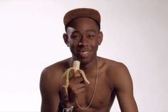 a man is holding a banana and listening to headphones