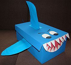 a blue paper box with a shark's mouth and sharp teeth on the inside