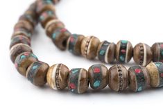 "Admire this special strand of handmade mala beads made from horn. Each little bead has been inlaid with brass, turquoise or color bits. The strand is approximately 28 long, and beads measure approximately 6-7 x 8mm. Beautiful brown color. Another great strand of beads to add to your collection! Bead Size: 6-7 x 8mm Strand Length: 28\" Approximate # of Beads: 108 Hole Size: 2mm Bone Species: Bubalus bubalis (Water Buffalo)  MORE BONE BEADS AVAILABLE  Browse our Etsy store for thousands of other Wooden Round Beads For Jewelry Making, Wooden Beads For Jewelry Making, Round Wooden Beads For Jewelry Making, Brown Beaded Necklaces With 8mm Round Beads, 8mm Rondelle Beads For Jewelry Making, Brown Jewelry With 8mm Oval Beads, Brown 8mm Round Beads, Brown 8mm Beads, Brown Jewelry With 8mm Round Beads