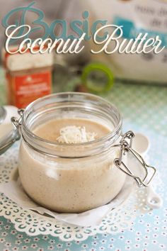 a glass jar filled with food sitting on top of a white doily next to a spoon