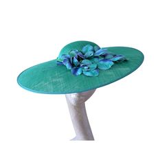 This is a stunning Emerald green shallow domed crown & flat brimmed hat with a Vintage 1940's/1950s Waxed flower vintage trim, As the crown is shallow it measures 54cm but will secure with a hat elasticPlease note:- Handmade in the United Kingdom Buyers outside of the UK  may need to pay customs fees or duties, which vary from country to country. Also, customs can sometimes delay delivery by many days. We want buyers to know that any customs delays are not our fault. Emerald Blue, Brimmed Hat, Floral Hat, Green Hat, Vintage 40s, Flower Vintage, Green Hats, Blue Trim, Ostrich Feathers