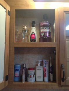 the medicine cabinet is stocked with all kinds of hygiene products and personal care items,