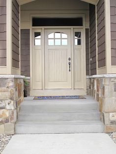 the front entrance to a house with stone steps