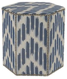 a blue and white ottoman with chains on it