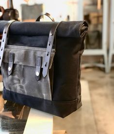 a black and gray bag sitting on top of a table