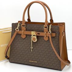 Nwt Authentic Michael Kors Logo At Front Snap Top Closure Gold Toned Hardware Luggage/ Brown Signature Color Mk Key & Lock On Front 4 Protective Feet Custom Mk Fabric Lining 1 Slip-In Pockets 1 Zipper Pocket 13" (L) X 9"(H) X 5"(D) Strap: 4", 18"- 24" Very Clean, Smoke-Free And Pet-Free Environment. Expensive Purses, Affliction Clothing, Studded Handbag, Michael Kors Satchel, Michael Kors Logo, Ladies Handbags, Black Satchel, Black Leather Satchel, Leather Satchel Handbags