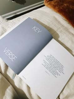 an open book sitting on top of a bed