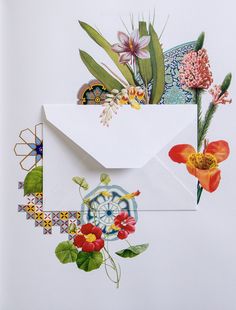 an envelope is decorated with flowers and leaves