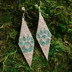 the earrings are made with seed beads and beaded in silver, blue and green