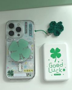 a cell phone case sitting next to a st patrick's day magnet and keychain