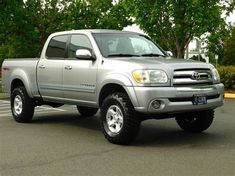 a silver truck parked in a parking lot