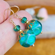 Lampwork glass bead earrings in colors of Turquoise-blue, light-green and white. Accenting these lovely colors are vintage brass bead caps and small Czech glass beads. All wire-wrapped with gold-filled wire, finished with gold-filled ear wires.  Perfect size for everyday wear, easily worn with office wear, evening wear or even with casual jeans.    Price: $25.00 Earring Length: 1 1/4 inch from the top of the ear wire to the bottom of the earrings.  Your earrings will arrive safe tucked into a complimentary gift box and uniquely packaged with care and loving attention. Thank you for visiting my jewelry shop, please come back again soon! Susan Burlington Vt, Glass Bead Earrings, Earrings Turquoise, Please Come Back, Lampwork Glass Beads, Bead Earrings, Bead Caps, Lovely Colors, Czech Glass Beads