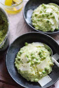 two black bowls filled with mashed potatoes and peas